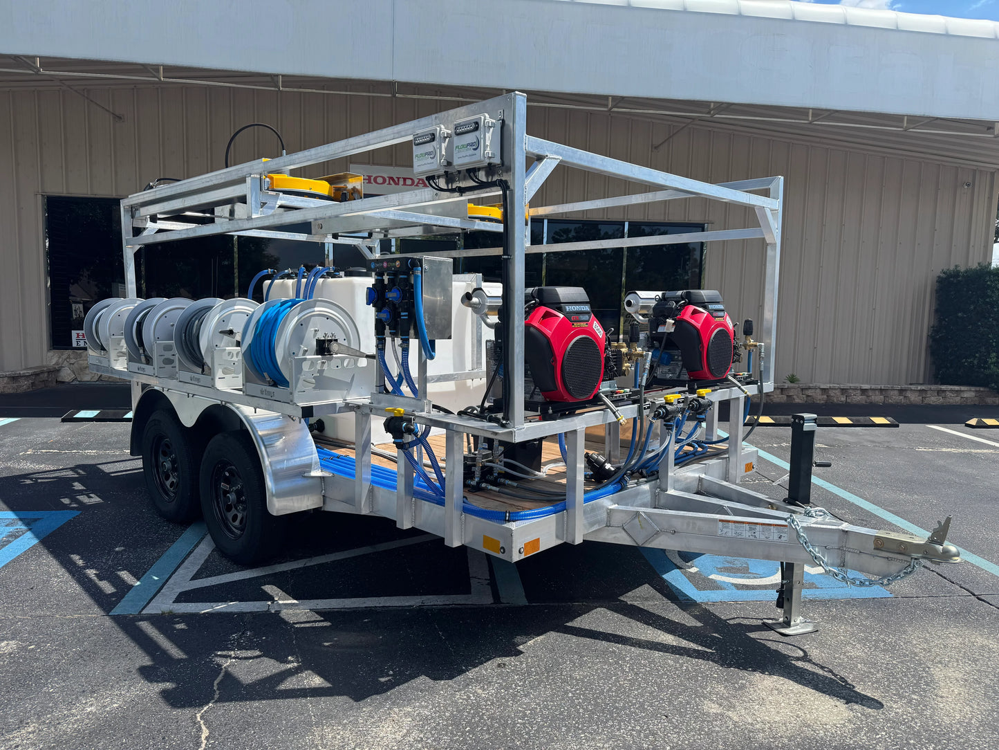 Professional softwash trailer with Honda pumps, hose reels, and tanks for exterior cleaning services.