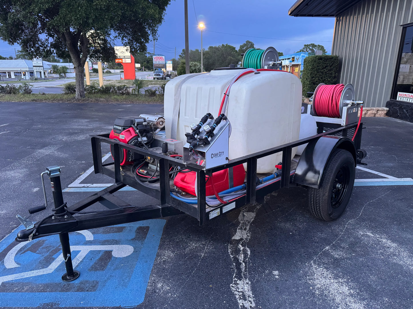 Softwash trailer with Honda engine, chemical tank, and hose reels for exterior cleaning equipment.