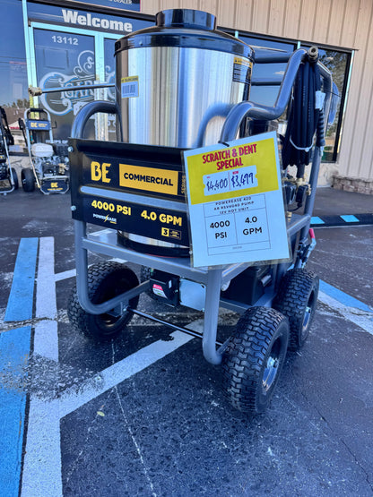 Commercial pressure washer with a scratch and dent sale sign in a parking lot.