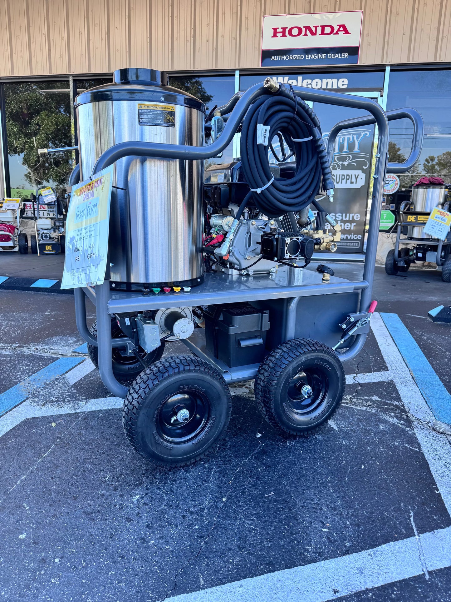 Pressure washer on a cart with a Honda sign in the background