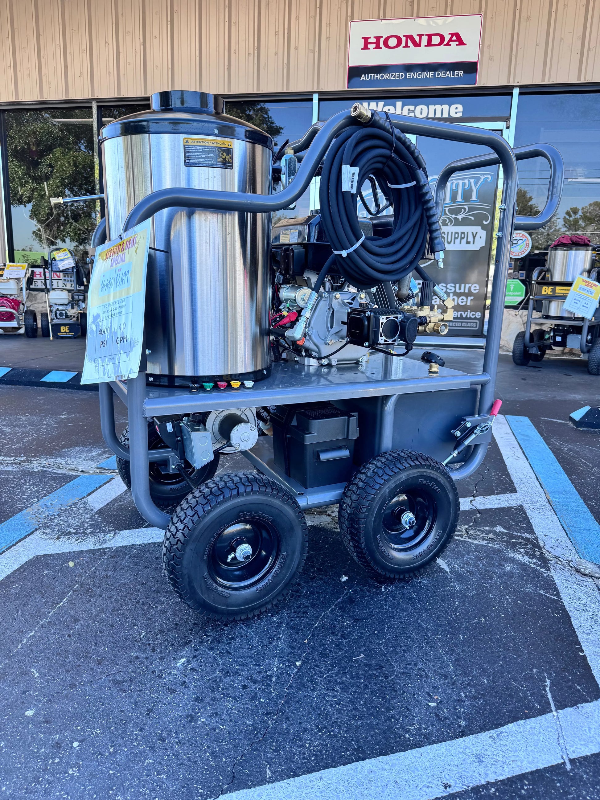 Pressure washer on a cart with a Honda sign in the background