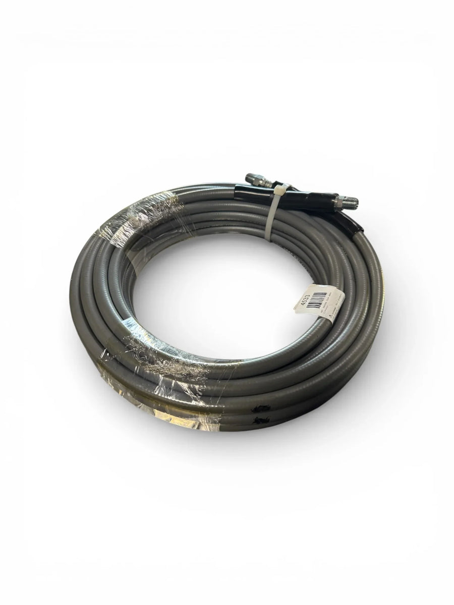 Coiled gray softwash hose with metal fittings, wrapped for shipping, ideal for pressure washing equipment.