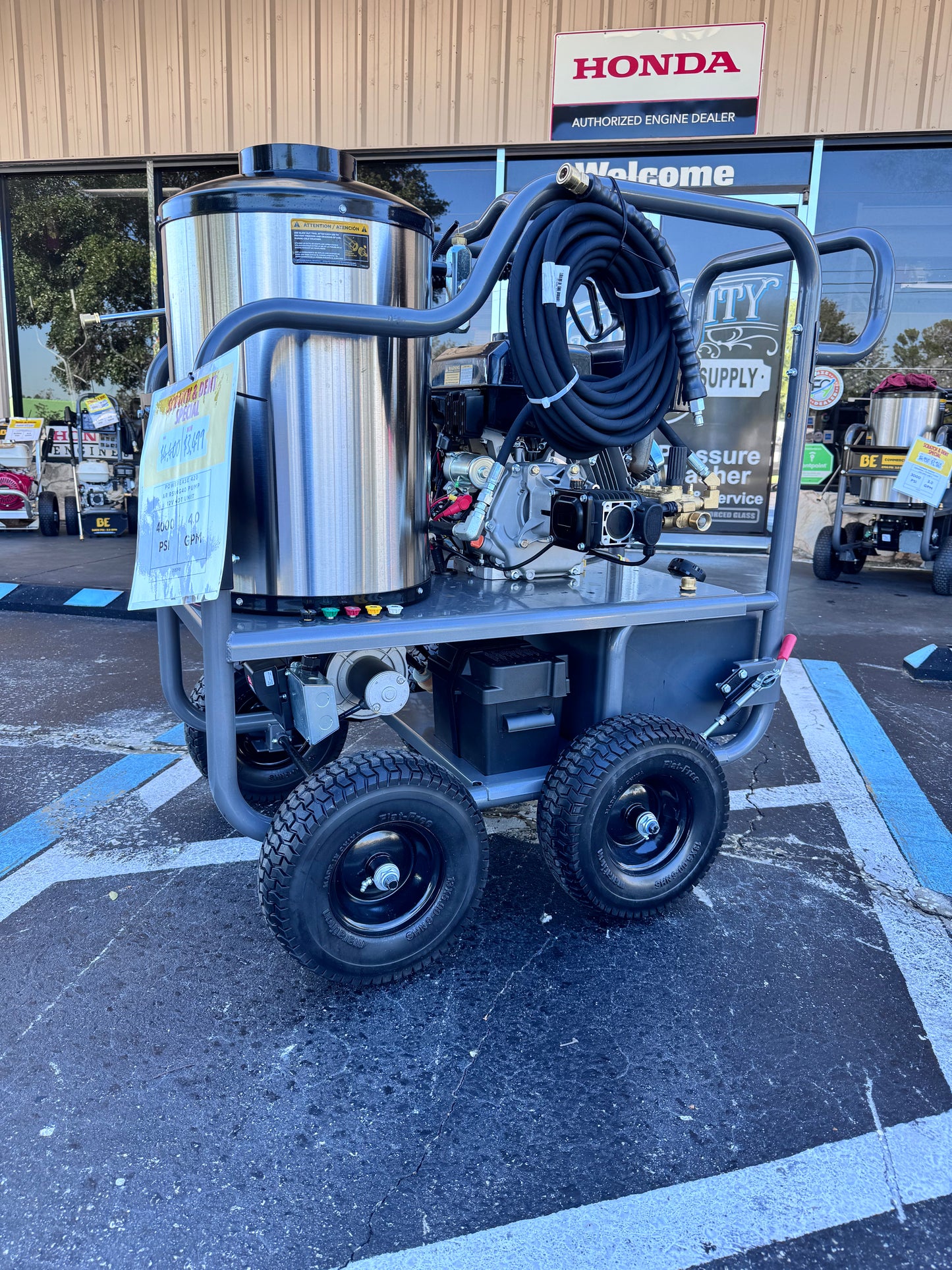 Pressure washer on a cart with a Honda sign in the background