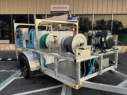 Softwash equipment trailer with Honda engine, hoses, and tanks for professional cleaning solutions
