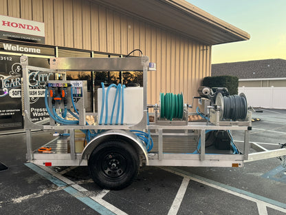 Softwash equipment trailer with hoses and tanks for pressure washing solutions