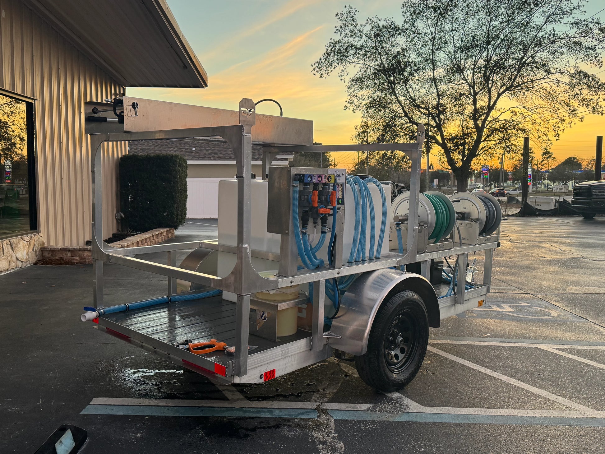 Softwash equipment trailer with hoses and tanks for professional cleaning solutions