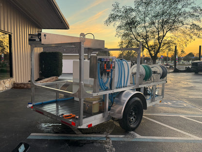 Softwash equipment trailer with hoses and tanks for professional cleaning solutions