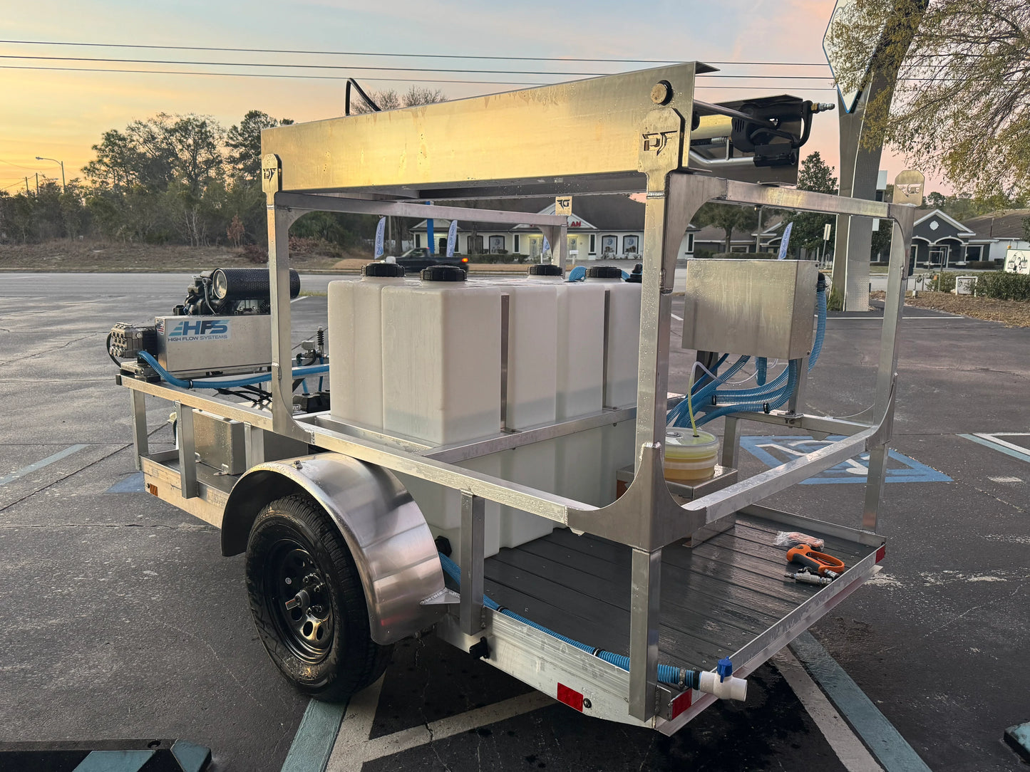 Softwash equipment trailer with tanks and hoses for professional cleaning solutions