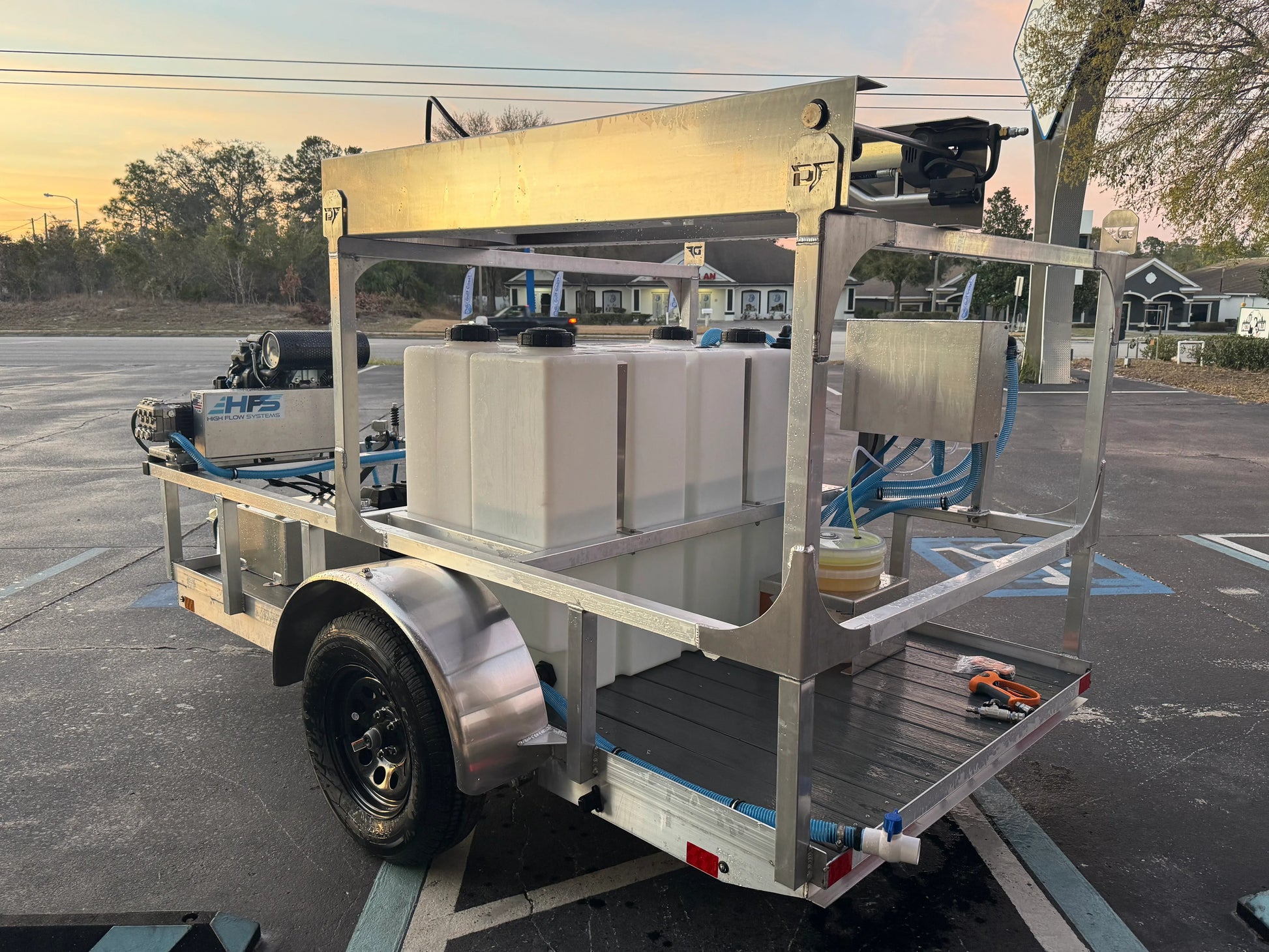Softwash equipment trailer with tanks and hoses for professional cleaning solutions