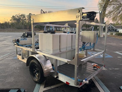 Softwash equipment trailer with tanks and hoses for professional cleaning solutions