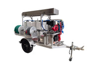 Professional softwash trailer with chemical tanks, hoses, and pressure washer for exterior cleaning