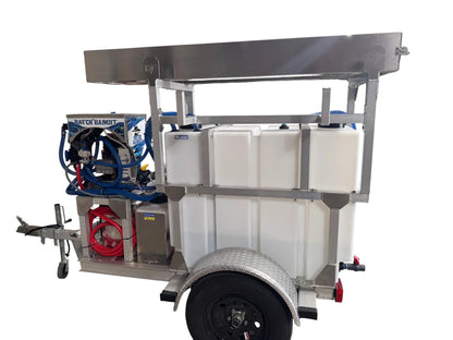 Mobile softwash trailer with water tanks, hoses, and cleaning equipment for professional exterior cleaning