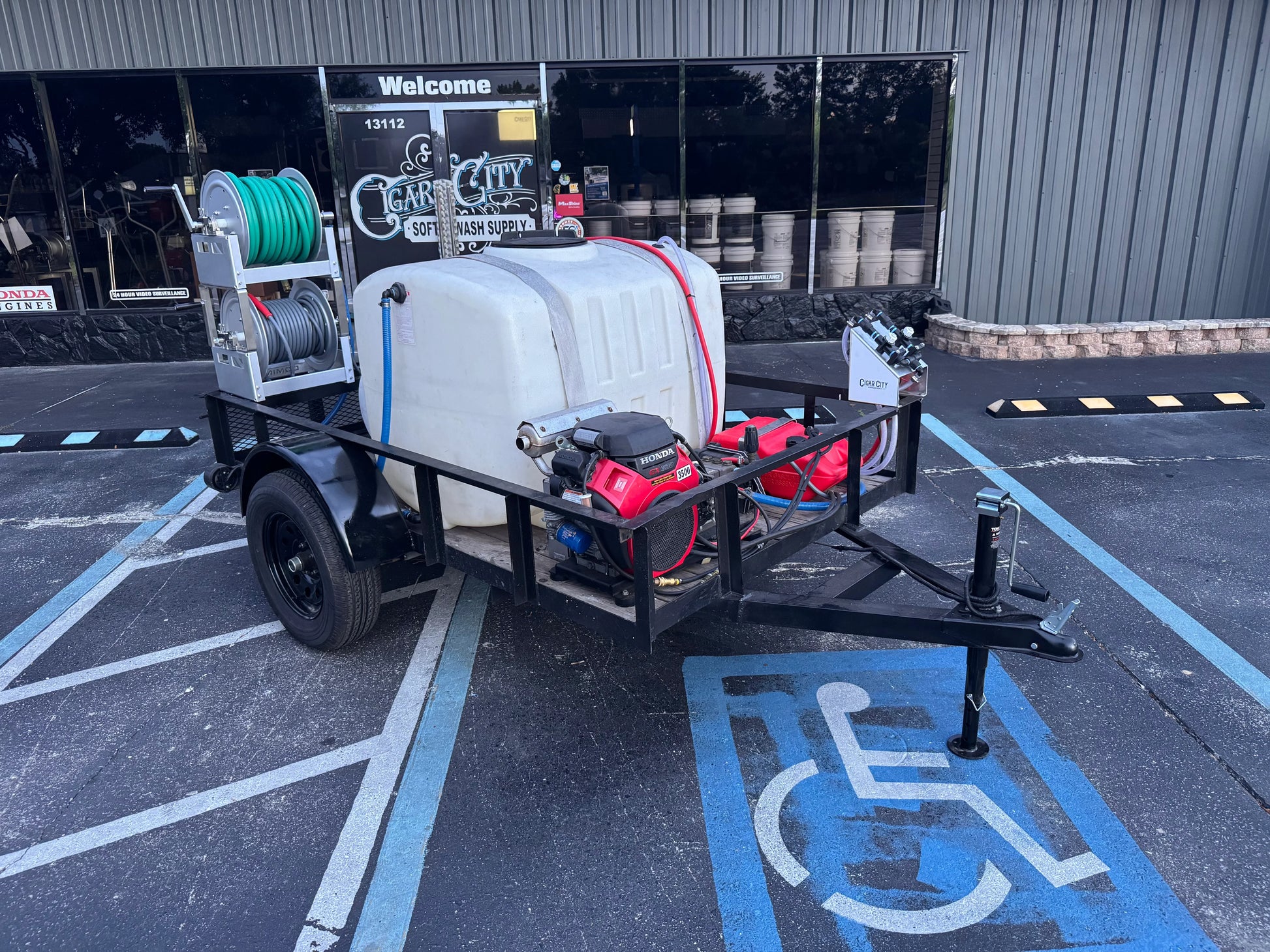 Softwash equipment trailer with Honda engine, hoses, and tank for professional cleaning solutions
