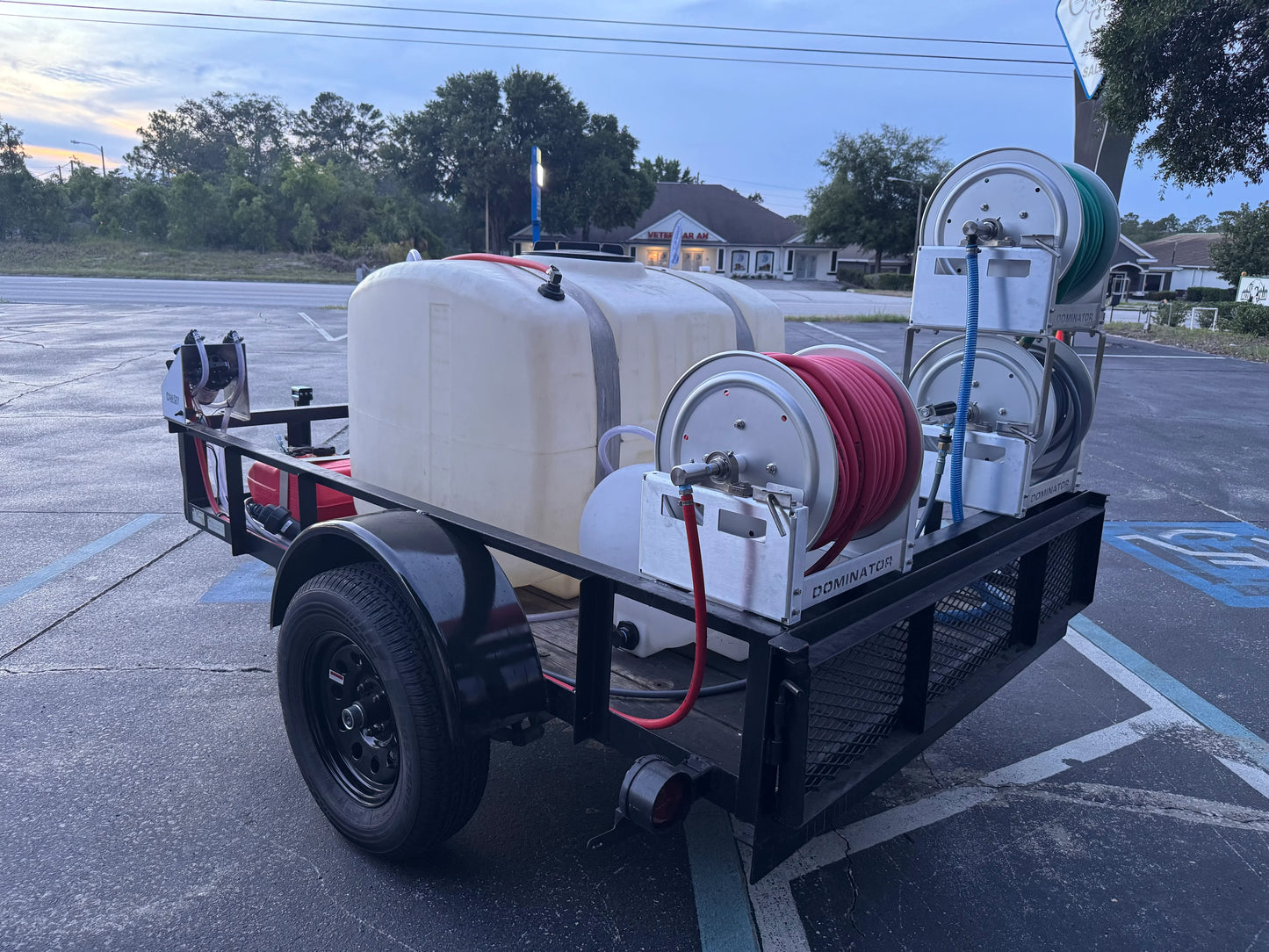 Softwash equipment trailer with tanks and hose reels for professional cleaning solutions