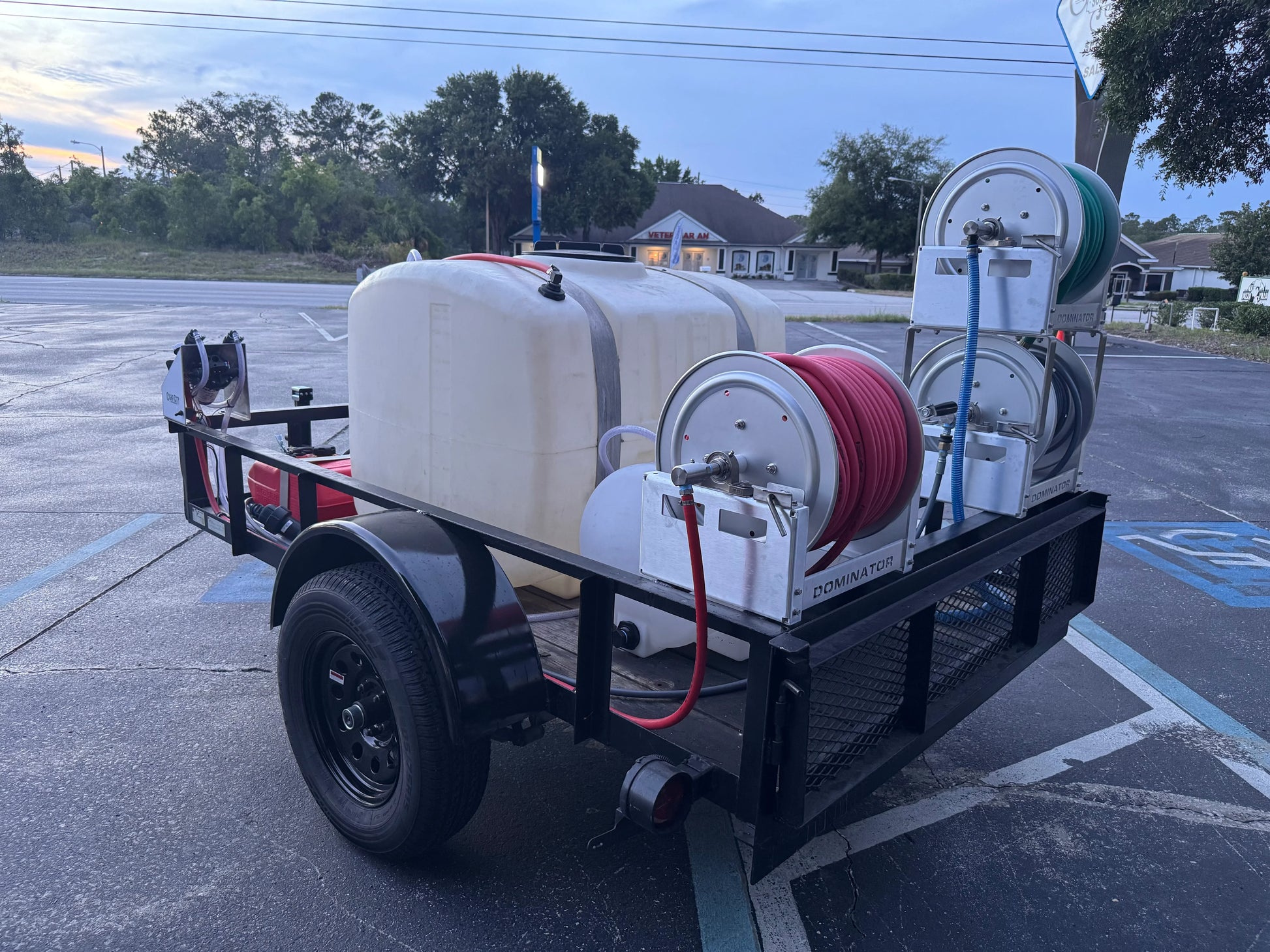 Softwash equipment trailer with tanks and hose reels for professional cleaning solutions