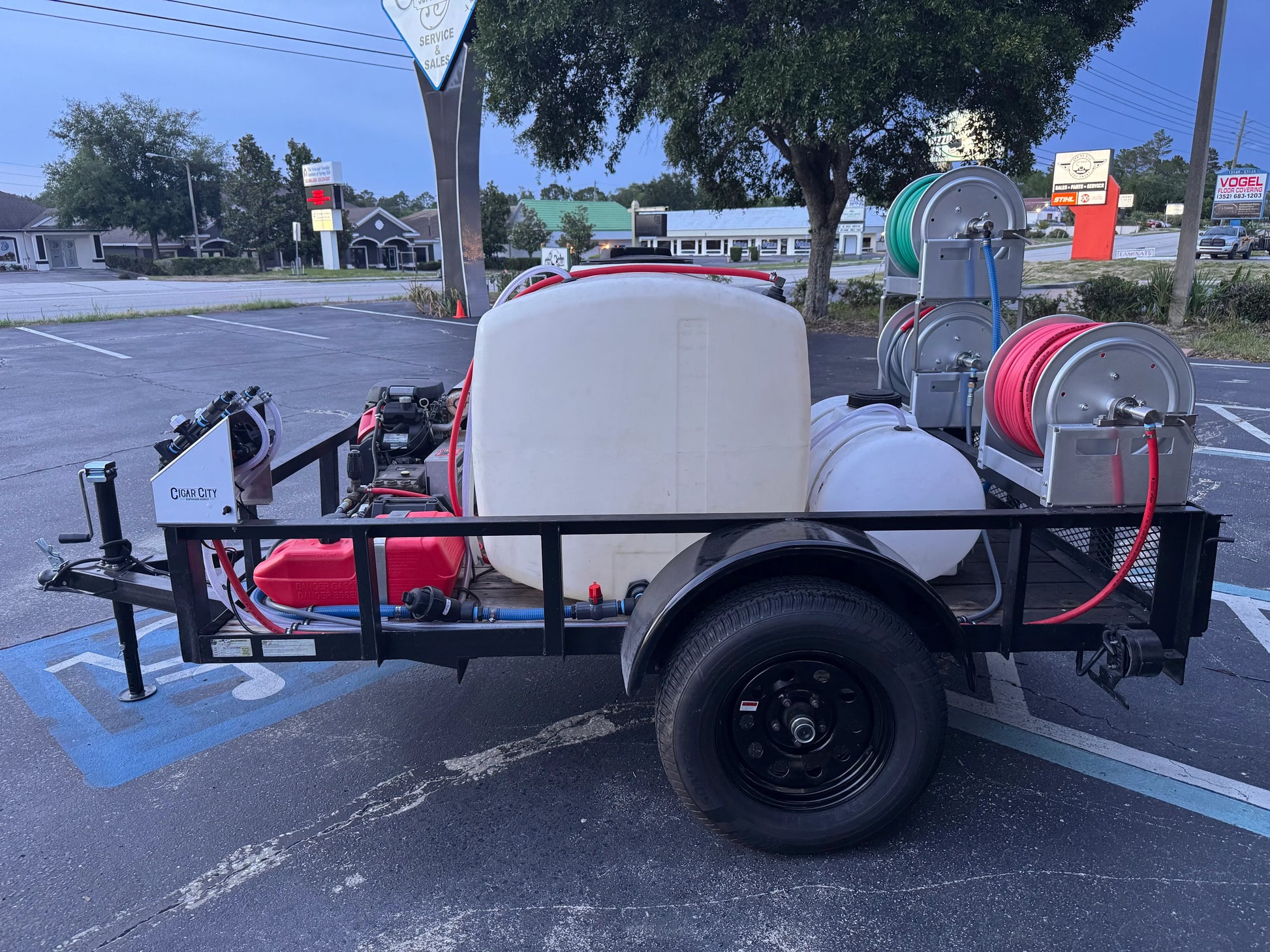 Softwash equipment trailer with tanks, hoses, and pressure washer for professional cleaning services