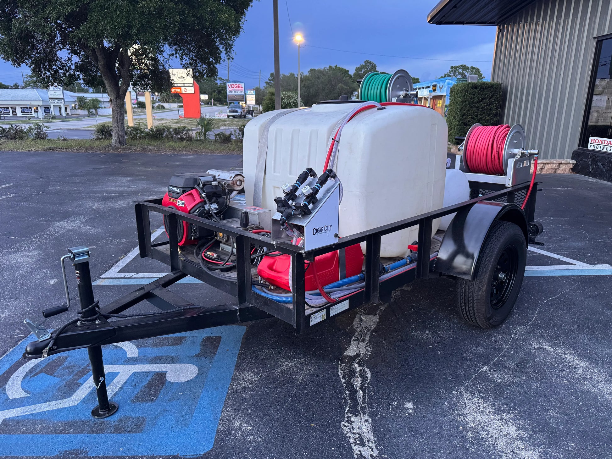 Softwash trailer with Honda engine, chemical tank, and hose reels for exterior cleaning equipment.