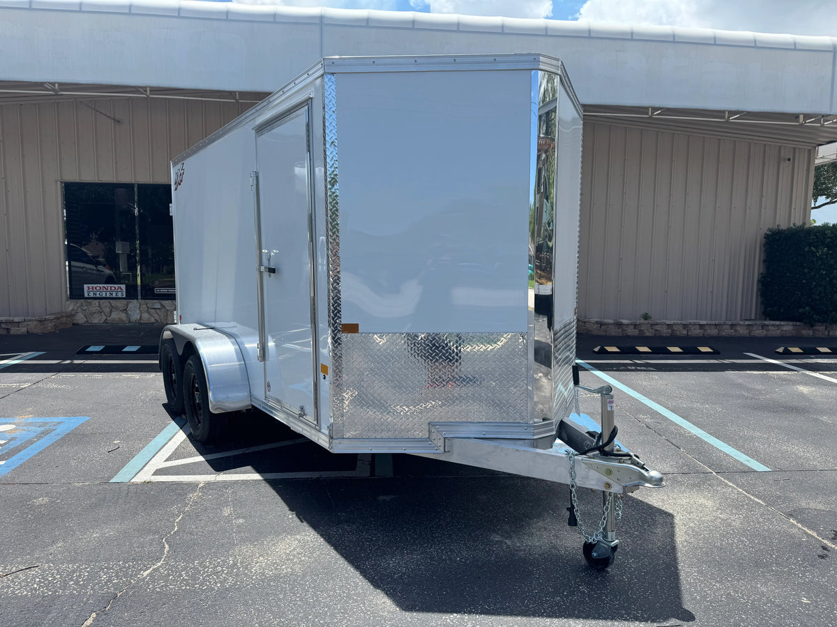 White enclosed utility trailer with diamond plate accents parked in lot