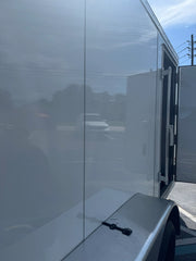White softwash equipment trailer with open rear doors under clear sky