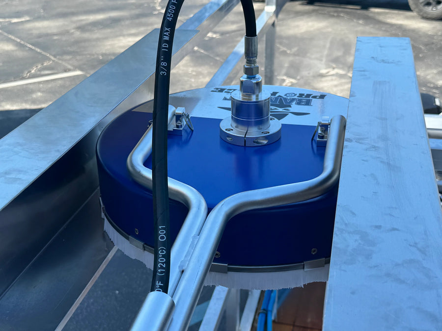 Blue softwash equipment with metal frame and high-pressure hose for professional cleaning solutions.