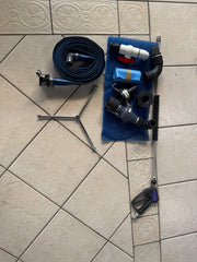 Softwash equipment including hose, nozzles, and pressure washer tools on tiled floor