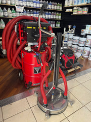 Red Sirocco softwash equipment with hoses and vacuum system in a cleaning supply store