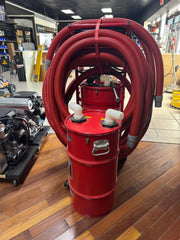 Red softwash equipment with coiled hoses and chemical tanks for pressure washing systems