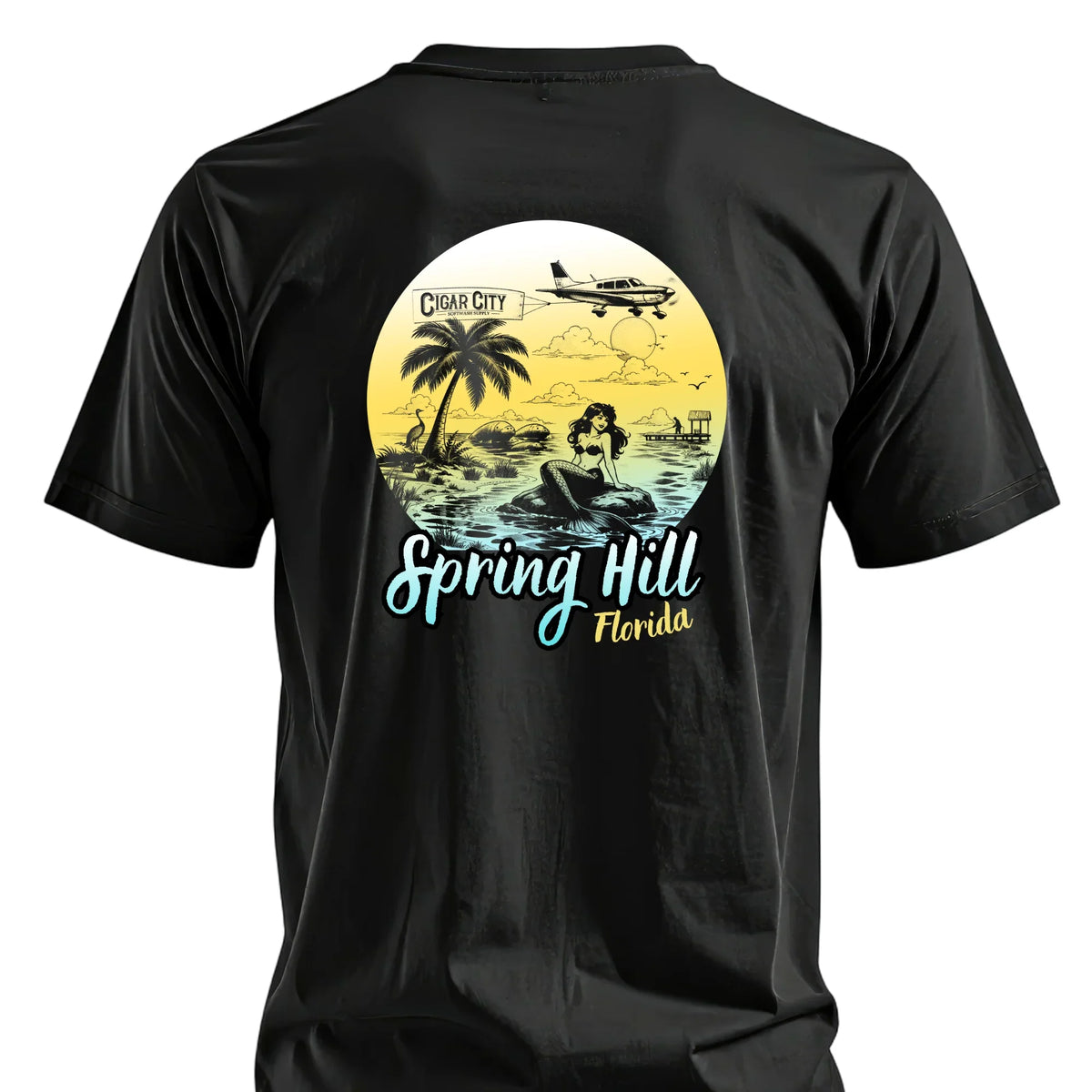 Black t-shirt with Spring Hill Florida mermaid graphic, palm tree, plane, and Cigar City Softwash Supply logo