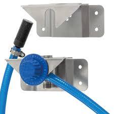 Blue hose connected to metal softwash equipment with pressure gauge for professional cleaning systems
