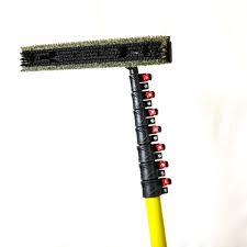 Softwash brush with red nozzles and yellow pole for pressure washing surfaces